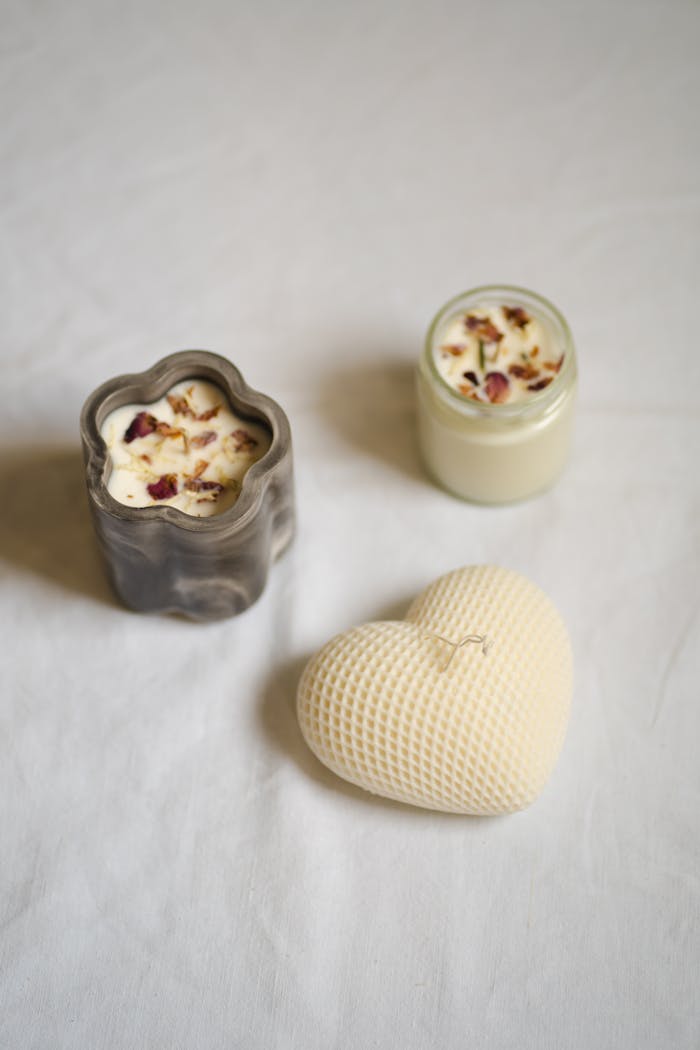 about-us-02 A minimalist still life featuring artisan candles in unique shapes, creating a serene and elegant atmosphere.