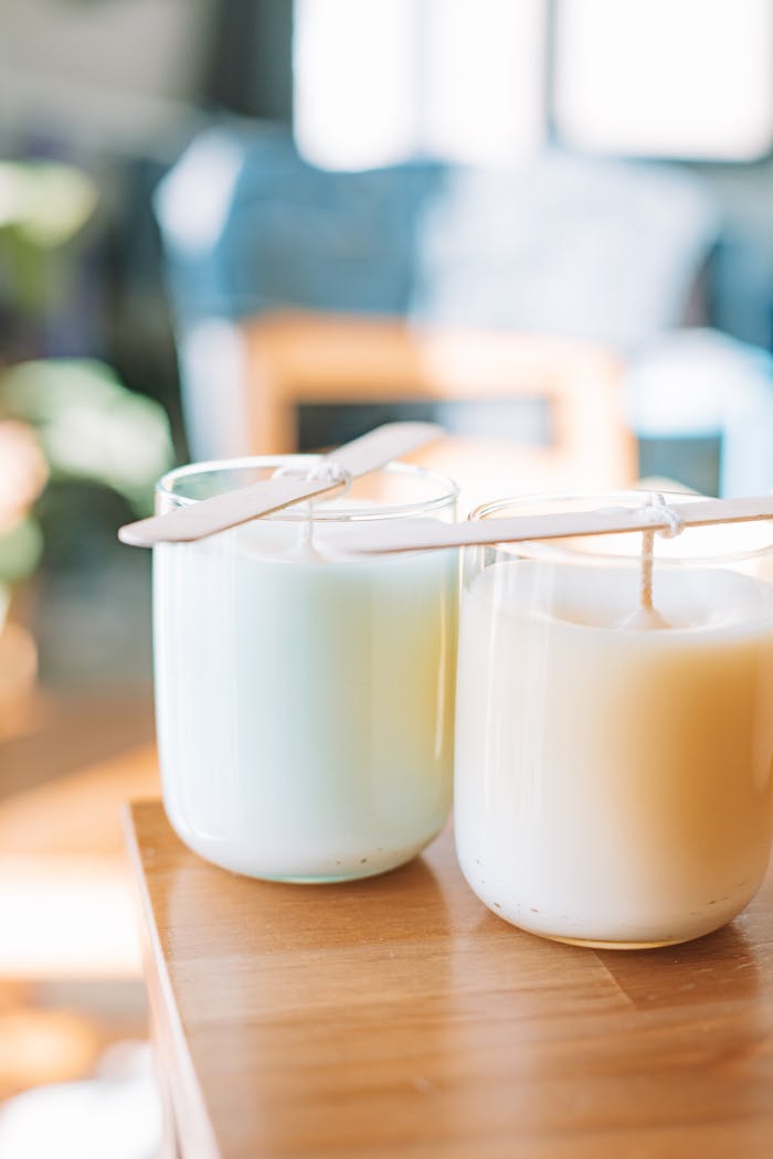 Mastering the First Impression: Your intriguing post title goes here Two homemade candles with popsicle stick supports, captured in warm natural light.