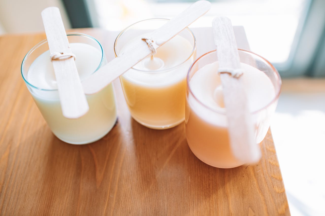 about-us-01 High-angle view of homemade scented candles with wooden wicks. Perfect for DIY crafts and home decor inspiration.