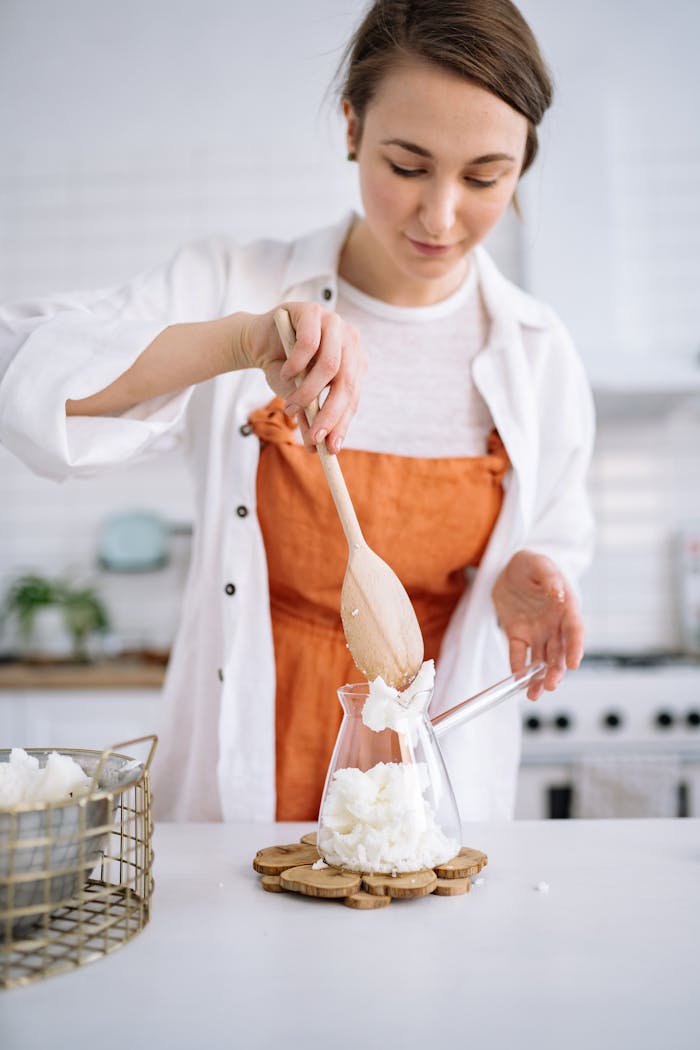 Crafting Captivating Headlines: Your awesome post title goes here A young woman making a handmade soy candle in a cozy indoor setting, showcasing creativity and craftsmanship.